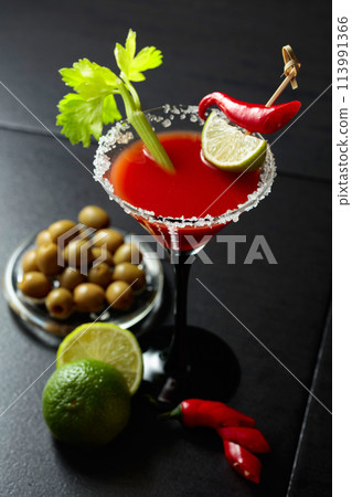 Bloody Mary cocktail with celery, lime, red pepper, and green olives. Bloody Mary cocktail with celery, lime, red pepper, and green olives. 113991366