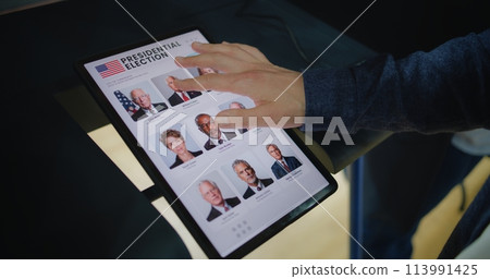 Close up of Caucasian man making choice and voting on tablet computer 113991425