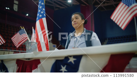 African American polling officer consults voters, gives bulletins African American polling officer consults voters, gives bulletins 113991580