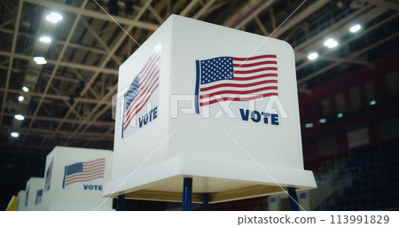 Voting booth with American flag logo at polling station 113991829