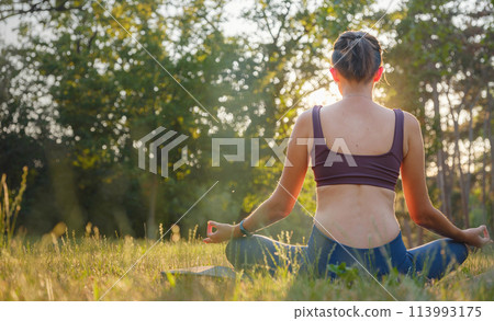 Young asian woman doing meditation in morning or evening at park, healthy woman relaxing and practicing yoga at city park. Mindfulness, destress, Healthy habits and balance concept Young asian woman doing meditation in morning or evening at park, healthy woman relaxing and practicing yoga at city park. Mindfulness, destress, Healthy habits and balance concept 113993175