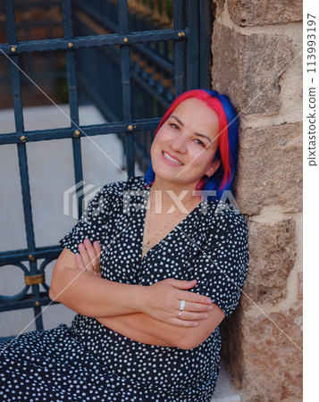 female summer old town walk in Antalya Turkey. woman with colorful hair and dress gracefully explores its historic streets. creating visual symphony that harmonizes past and present. 113993197