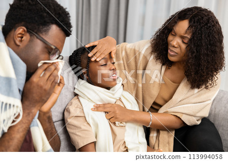 Caring Parents Comforting Sick Child At Home Together 113994058