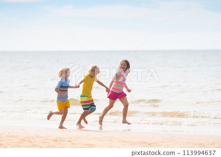 Kids play on tropical beach. Sand and water toy. Kids play on tropical beach. Sand and water toy. 113994637