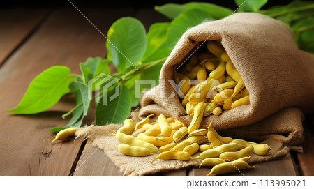 Yellow beans spill from a rustic sack.AI Generated 113995021