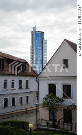 A tall business center behind the old two-storey houses 113995354