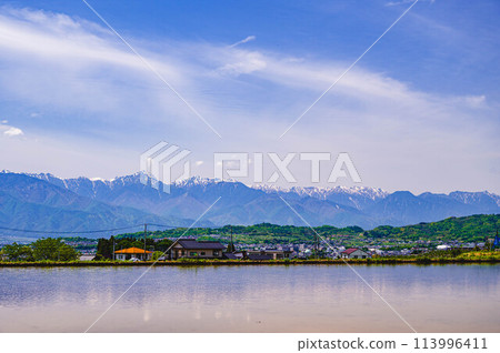When water fills the rice fields of Azumino 113996411