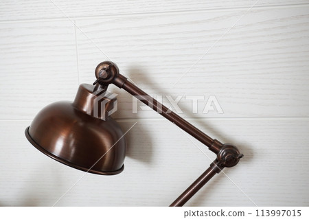 close up of metal desk lamp with space copy on concreat background home interier decoration close up of metal desk lamp with space copy on concreat background home interier decoration 113997015
