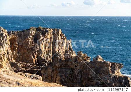 The cliffs of the cliffs of the cliffs and the horizon seen in the distance The cliffs of the cliffs of the cliffs and the horizon seen in the distance 113997147