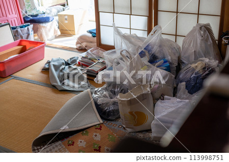 A mountain of trash piled up in a Japanese-style room while sorting through belongings from the family home 113998751