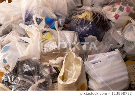 A mountain of trash piled up in a Japanese-style room while sorting through belongings from the family home 113998752