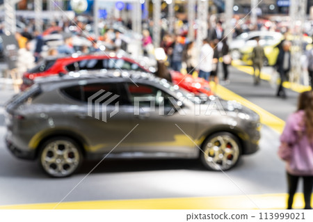 Blurred background of car show exposition. Blurred background of car show exposition. 113999021