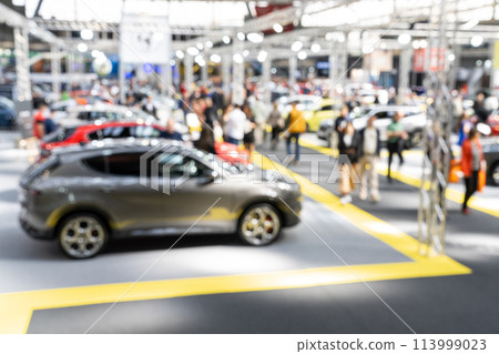 Blurred background of car show exposition. Blurred background of car show exposition. 113999023
