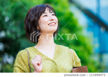 A woman in a dress enjoying shopping A woman in a dress enjoying shopping 113999473