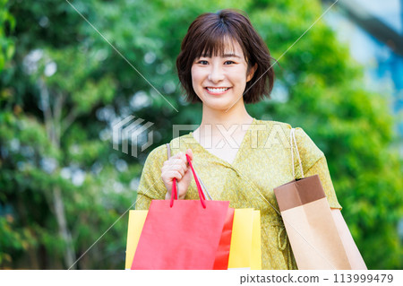 A woman in a dress enjoying shopping A woman in a dress enjoying shopping 113999479