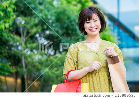 A woman in a dress enjoying shopping A woman in a dress enjoying shopping 113999553