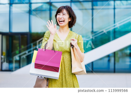 A woman in a dress enjoying shopping A woman in a dress enjoying shopping 113999566