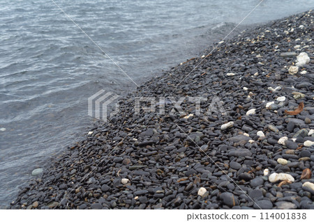Granite gravel stone rocks flooring pattern surface texture on sea lake. Close-up of exterior material for design decoration background. Rubble 114001838