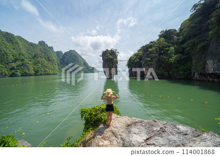 A tourist travel at Khao Phing Kan, Ko Ta Pu, Phang Nga, lush green trees from above in tropical forest in national park in summer season. Natural landscape background. 114001868