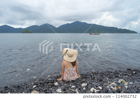 Happy Asian woman, a sexy Thai lady, relaxing and enjoying at turquoise sea near Phuket beach in summer during travel holidays vacation trip outdoors at natural ocean or island at noon, Thailand. Happy Asian woman, a sexy Thai lady, relaxing and enjoying at turquoise sea near Phuket beach in summer during travel holidays vacation trip outdoors at natural ocean or island at noon, Thailand. 114002732
