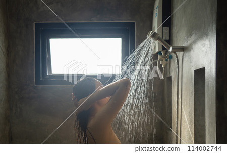 A woman taking a shower at home. People lifestyle. 114002744