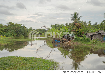 Fishing trap net in canal with fisherman urban city village town houses, lake or river. Nature landscape fisheries and fishing tools at Pak Pha, Songkhla, Thailand. Aquaculture farming 114002760