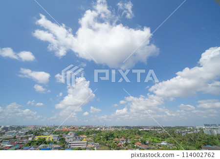 Clear blue sky with white fluffy clouds at noon. Day time. Abstract nature landscape background. Clear blue sky with white fluffy clouds at noon. Day time. Abstract nature landscape background. 114002762