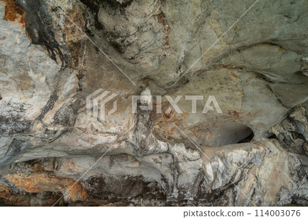 Natural stalactite and stalagmite rock stone cliff hang from cave ceiling in cave with lake river sea. Environmental explore. Landscape background. Erosion 114003076