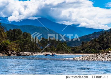 Punakha, Bhutan - Tourists ride on the rafting facility, providing an interesting experience for travel enthusiasts 114004095