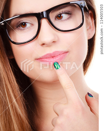 Nerdy teenage in eyeglasses thinking about something Nerdy teenage in eyeglasses thinking about something 114005503