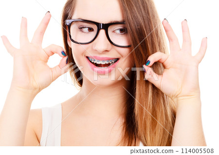 Happy nerdy teenage with brace wearing eyeglasses 114005508