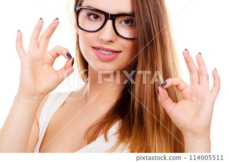 Happy nerdy teenage with brace wearing eyeglasses 114005511