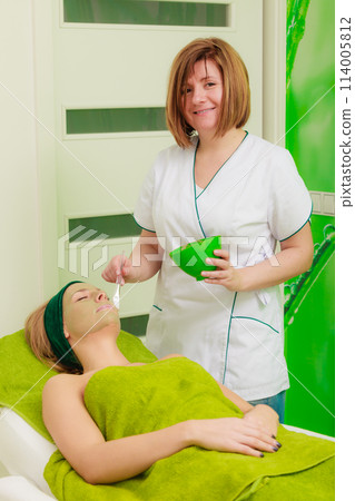 Woman having algae mud mask on face Woman having algae mud mask on face 114005812