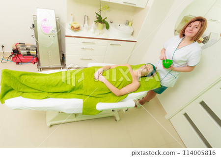 Woman having algae mud mask on face Woman having algae mud mask on face 114005816