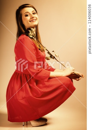 Fashion woman teen girl in red gown with dry rose. Fashion woman teen girl in red gown with dry rose. 114006036