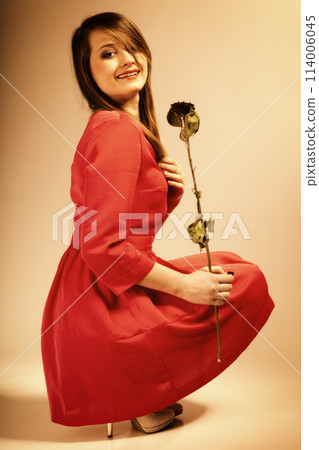 Fashion woman teen girl in red gown with dry rose. 114006045