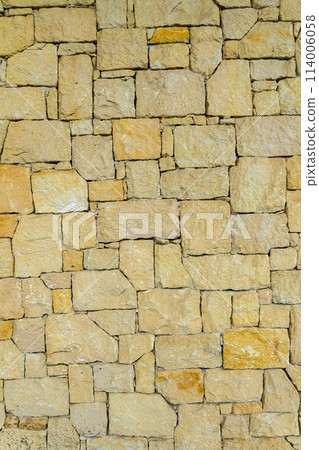 real stone wall made of yellow stone 1 114006058