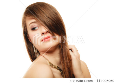 Portrait of girl with bang covering eye in golden necklace 114006060
