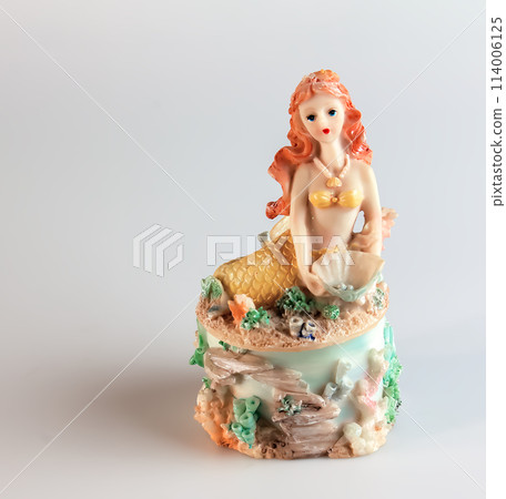 Mermaid figurine on a white background. Fairytale character. Toy mermaid. Feminine appearance Mermaid figurine on a white background. Fairytale character. Toy mermaid. Feminine appearance 114006125