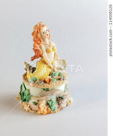 Mermaid figurine on a white background. Fairytale character. Toy mermaid. Feminine appearance Mermaid figurine on a white background. Fairytale character. Toy mermaid. Feminine appearance 114006126