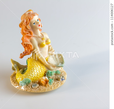 Mermaid figurine on a white background. Fairytale character. Toy mermaid. Feminine appearance Mermaid figurine on a white background. Fairytale character. Toy mermaid. Feminine appearance 114006127