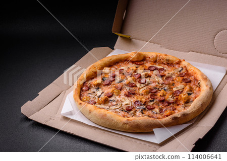 Delicious pizza with sausage, cheese, tomatoes, salt, spices and herbs 114006641
