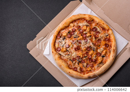 Delicious pizza with sausage, cheese, tomatoes, salt, spices and herbs 114006642