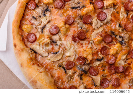 Delicious pizza with sausage, cheese, tomatoes, salt, spices and herbs Delicious pizza with sausage, cheese, tomatoes, salt, spices and herbs 114006645