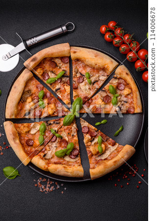 Delicious pizza with sausage, cheese, tomatoes, salt, spices and herbs 114006678