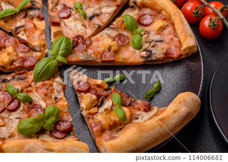Delicious pizza with sausage, cheese, tomatoes, salt, spices and herbs Delicious pizza with sausage, cheese, tomatoes, salt, spices and herbs 114006681