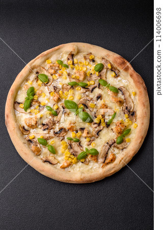 Delicious pizza with corn, cheese, tomatoes and mushrooms, salt, spices and herbs 114006698