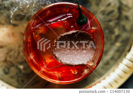 Alcoholic drink. A cocktail with elite alcohol on dark black background Alcoholic drink. A cocktail with elite alcohol on dark black background 114007130