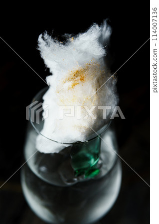 Alcoholic drink. A cocktail with elite alcohol on dark black background Alcoholic drink. A cocktail with elite alcohol on dark black background 114007136