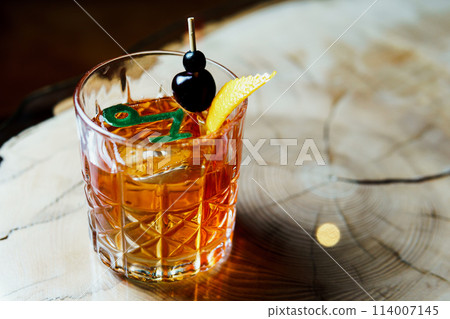Alcoholic drink. A cocktail with elite alcohol on dark black background Alcoholic drink. A cocktail with elite alcohol on dark black background 114007145